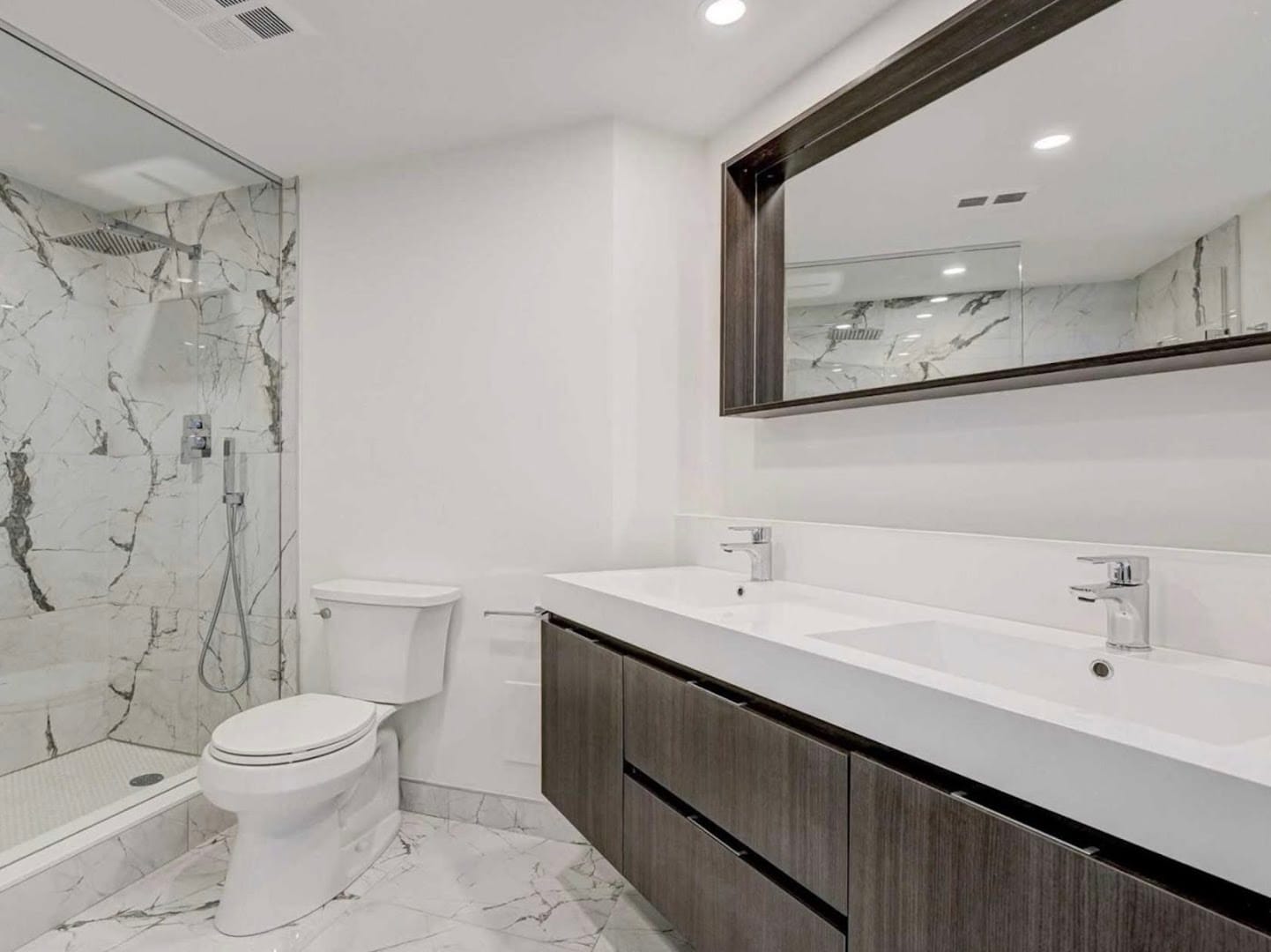 Marble-tiled bathroom renovation completed by Condo Handyman